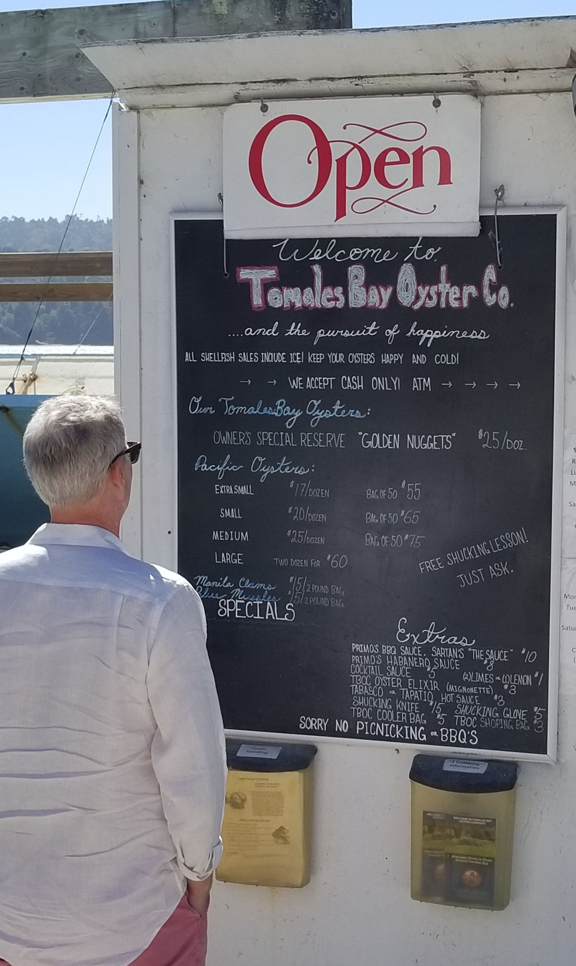 Tom studying the Tomales Bay Oyster Company Menu